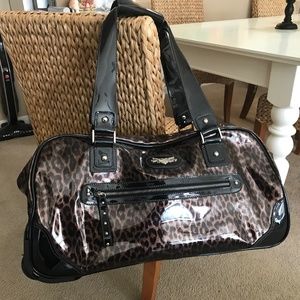 Leopard print and black faux patent leather rolling duffel bag